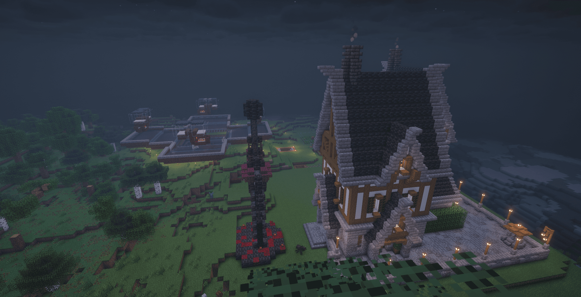 the same mansion at dusk with a nether-brick sculpture out front