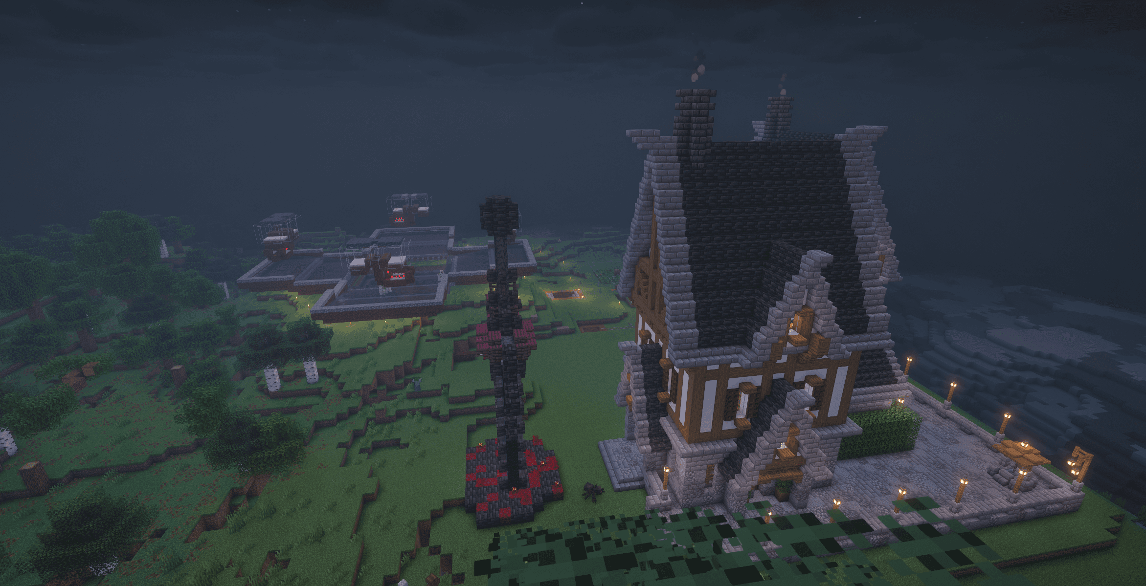 the same mansion at dusk with a nether-brick sculpture out front